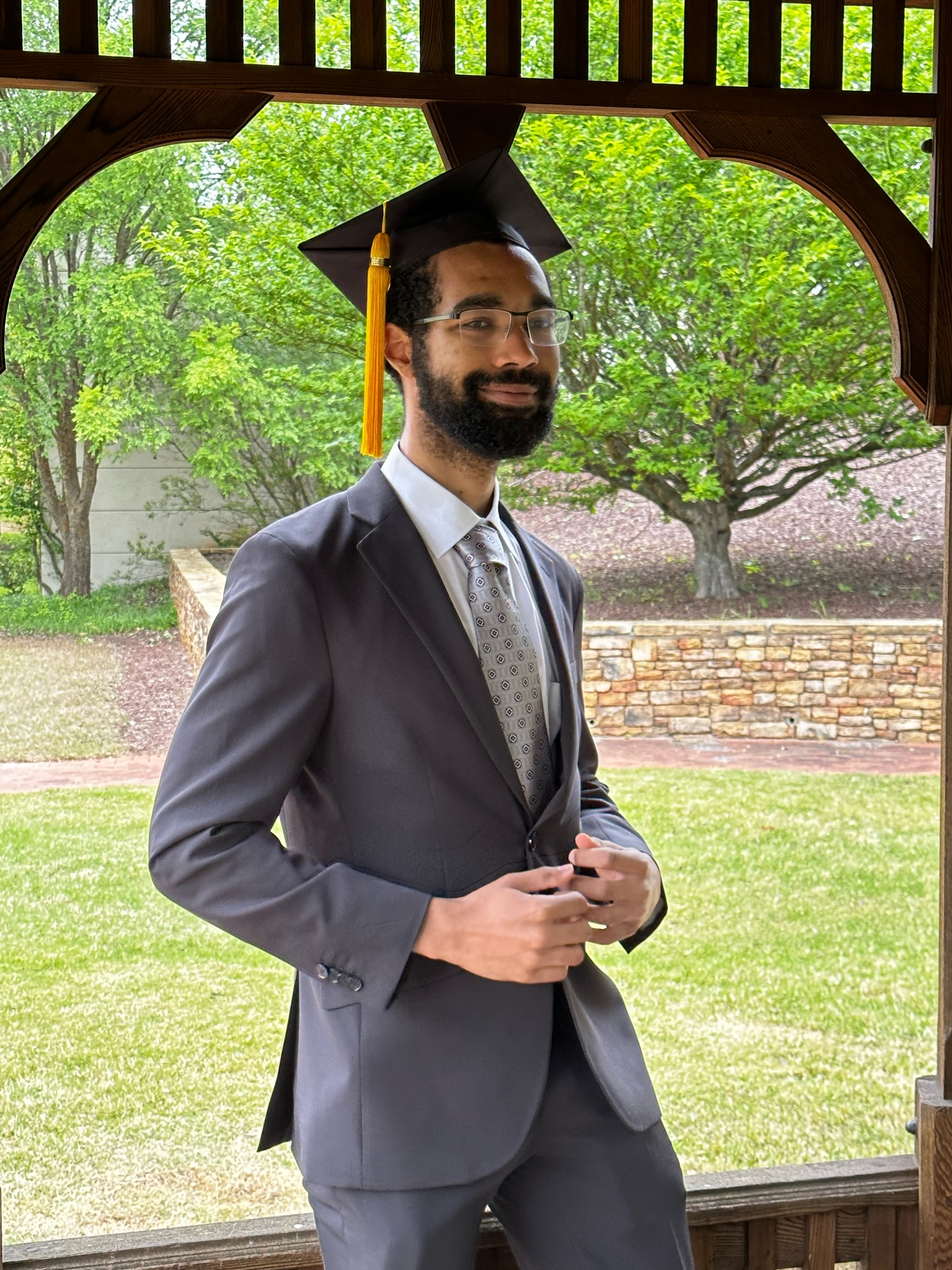 Milo in a suit and graduation cap
